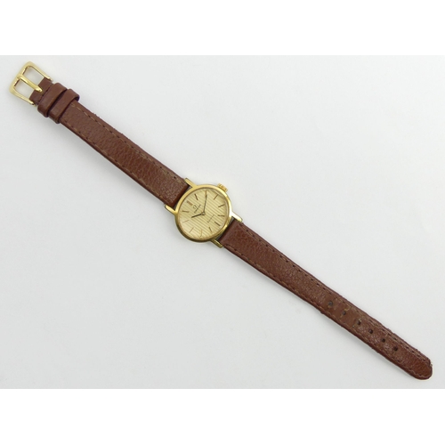 158 - Ladies Omega gold tone manual wind watch on a leather strap. 25 mm wide. UK Postage £12.
Condition r... 