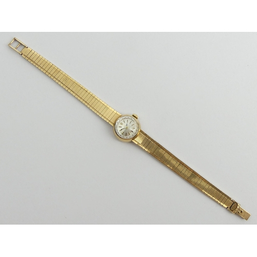 165 - Ladies 9ct gold Omega watch and strap with a manual wind movement, 28.2 grams gross. 18.5 cm x 18 mm... 