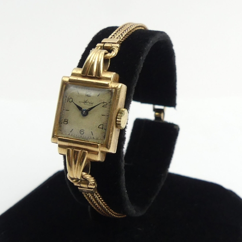 176 - 9ct gold ladies wristwatch and strap, 16.4 grams gross. Watch 17 mm wide. UK Postage £12.