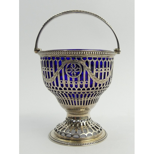 186 - Silver pierced sugar basket (un-marked) with a swing handle and blue glass liner. 127 grams exc. lin... 