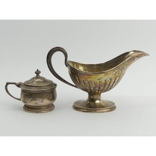 217 - Mappin & Webb silver mustard pot, Birm.1933 and a Victorian silver sauce boat, Birm.1889. 301 grams.... 