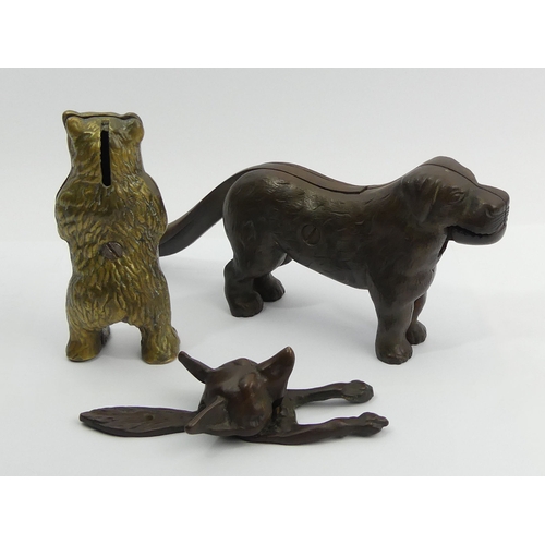 270 - A brass bear money box, a fox design door knocker and a dog design nutcracker. UK Postage £15.