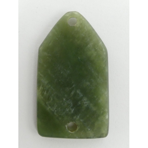 280 - Chinese jade pendant/belt fastener, carved with a bird amongst foliage. 60 x 35 mm. UK Postage £12.