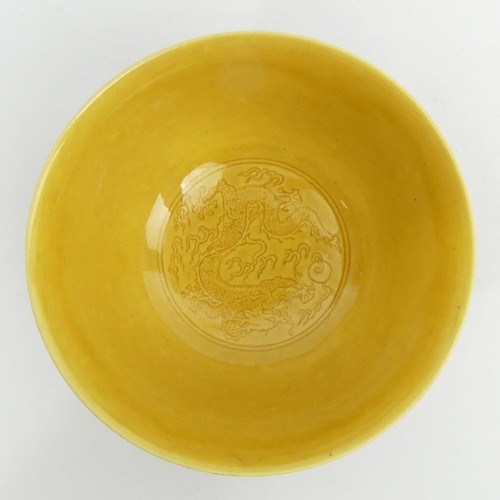 290A - Ochre glazed Chinese porcelain dragon design bowl with a six character mark. 13 x 7 cm. UK Postage £... 