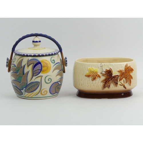 308 - Art Deco Poole pottery biscuit barrel and a Sylvac vase. Barrel 16 cm high. UK Postage £14.