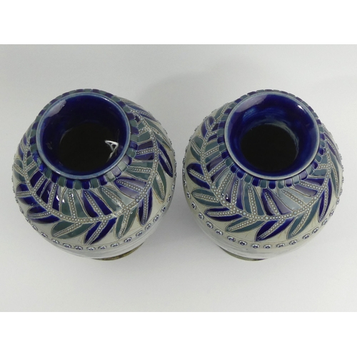 324 - A pair of Doulton Lambeth Hannah Barlow art pottery vases, decorated with a sgraffito design of hors... 