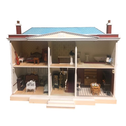 265B - A large dolls house with a fittted interior and furniture. Postage not available.