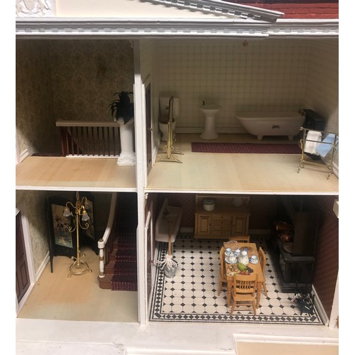 265B - A large dolls house with a fittted interior and furniture. Postage not available.