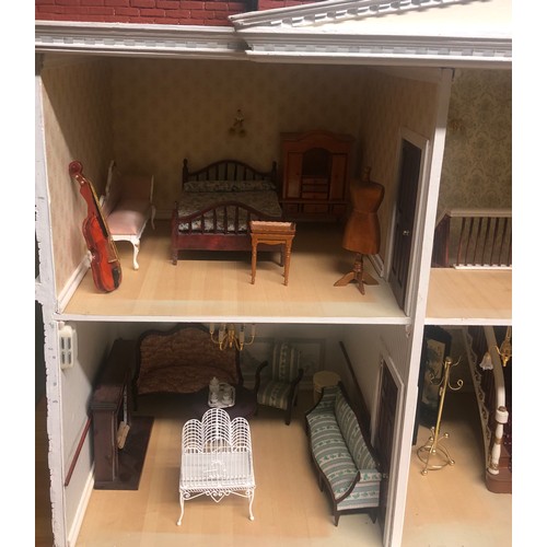 265B - A large dolls house with a fittted interior and furniture. Postage not available.