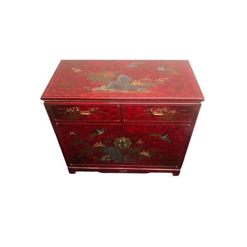 390 - A Chinese style lacquer ware cabinet of two drawers over two cupboard doors. 91 x 45 x 80 cm. Postag... 