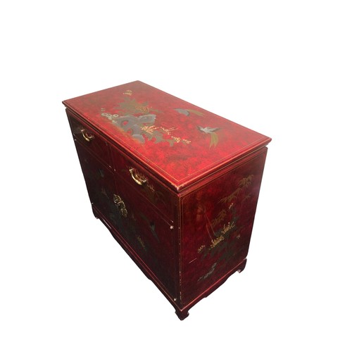 390 - A Chinese style lacquer ware cabinet of two drawers over two cupboard doors. 91 x 45 x 80 cm. Postag... 