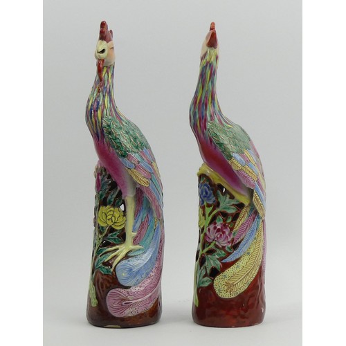 285 - A pair of Chinese famille rose palette Asiatic pheasant figures. 26 cm. UK Postage £14.