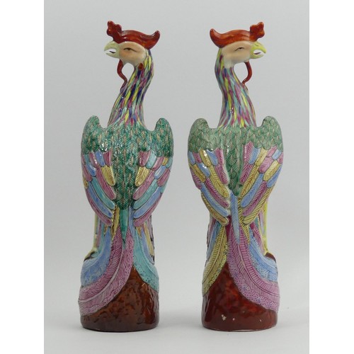 285 - A pair of Chinese famille rose palette Asiatic pheasant figures. 26 cm. UK Postage £14.