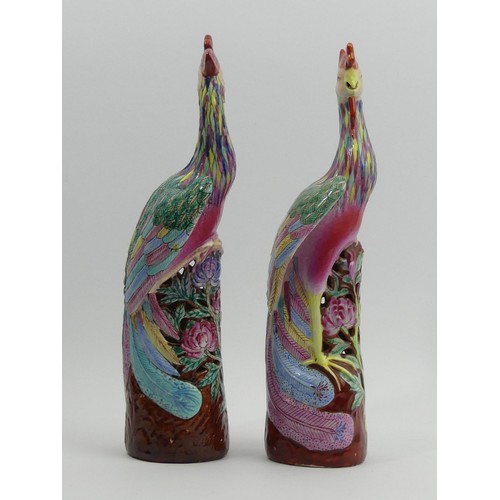 285 - A pair of Chinese famille rose palette Asiatic pheasant figures. 26 cm. UK Postage £14.