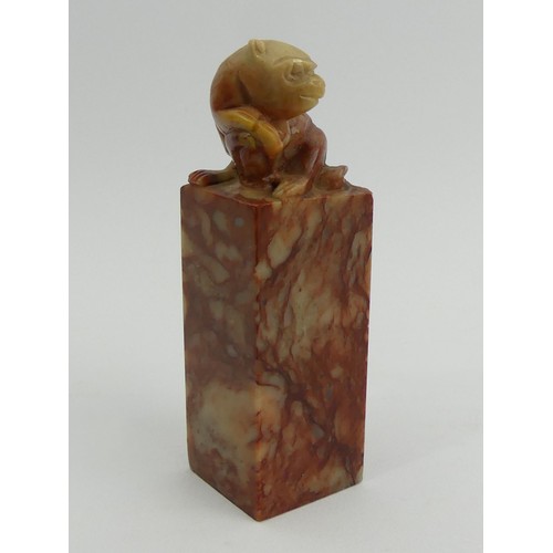 289 - A Chinese carved soapstone seal with a monkey to the top. 9.5 cm. UK Postage £12.