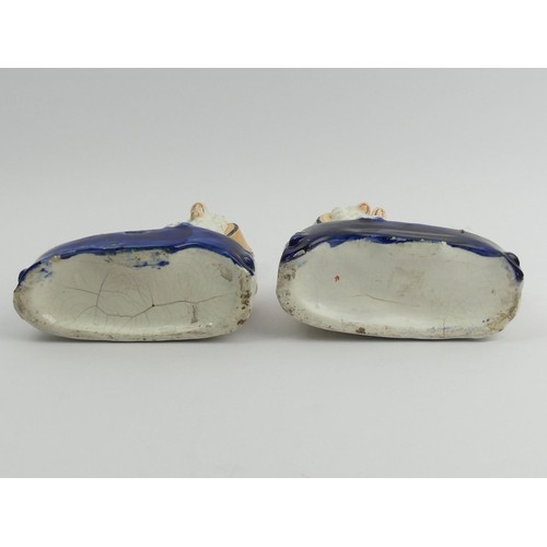 302 - A pair of Victorian Staffordshire pottery spaniel inkwells. 14 cm high. UK Postage £12.