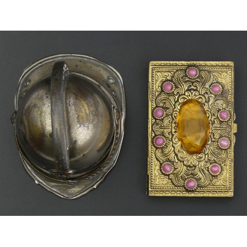 248A - A novelty match holder and striker in the form of a firemans helmet and a Bohemian paste set cigaret... 