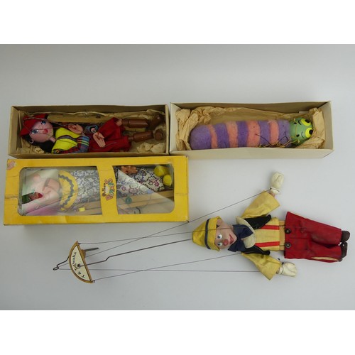 356 - Three Pelham boxed puppets, The Caterpillar, The Clown and The Cowgirl along with a Pinnochio puppet... 