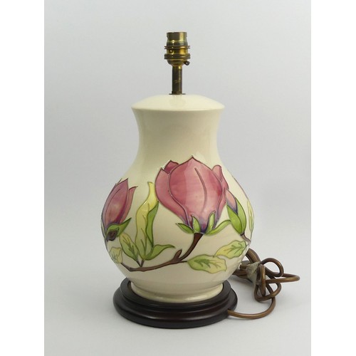 293 - A large Moorcroft Magnolia pattern pottery table lamp, 35 cm. UK Postage £20.