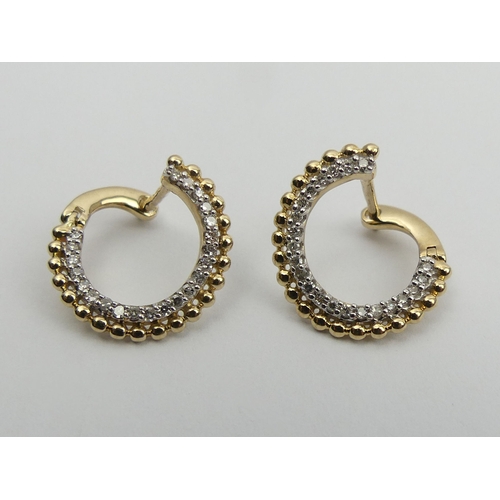 1 - A pair of 9ct gold diamond set  earrings, 2.1 grams. 9 mm diameter. UK Postage £12.