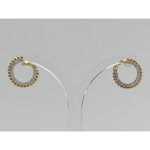 1 - A pair of 9ct gold diamond set  earrings, 2.1 grams. 9 mm diameter. UK Postage £12.