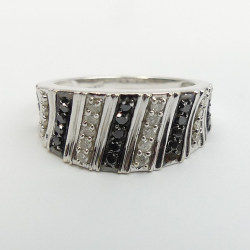 13 - 9ct gold black and white diamond set ring, 4.1 grams. Size N, 9 mm wide. UK Postage £12.