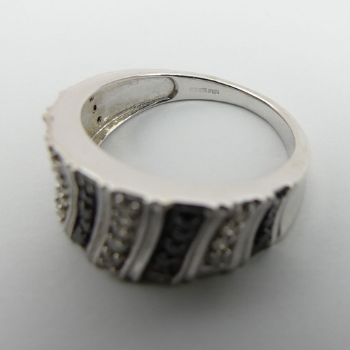 13 - 9ct gold black and white diamond set ring, 4.1 grams. Size N, 9 mm wide. UK Postage £12.