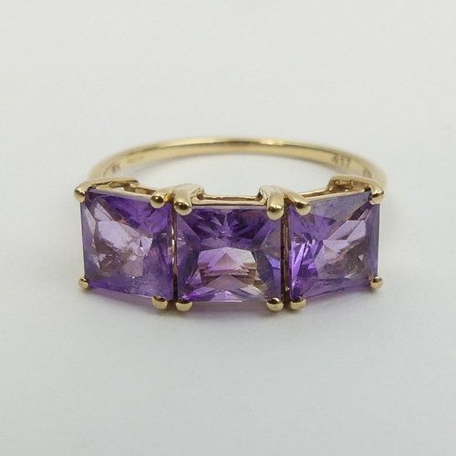 16 - 9ct gold amethyst three stone ring, 2.5 grams. Size Q, 7.4 mm. UK Postage £12.