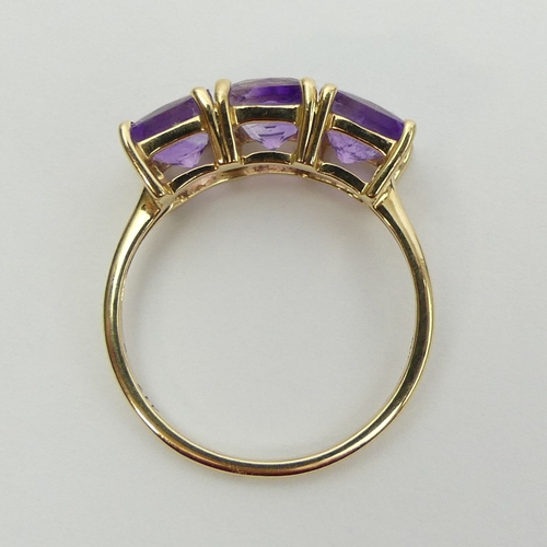 16 - 9ct gold amethyst three stone ring, 2.5 grams. Size Q, 7.4 mm. UK Postage £12.