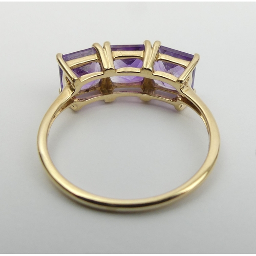 16 - 9ct gold amethyst three stone ring, 2.5 grams. Size Q, 7.4 mm. UK Postage £12.