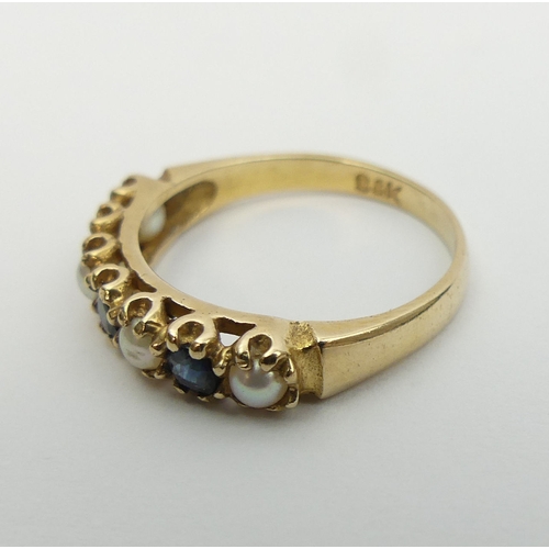 21 - 9ct gold sapphire and seed pearl ring, London 1975. 2 grams, Size M, 4.3 mm wide. UK Postage £12.