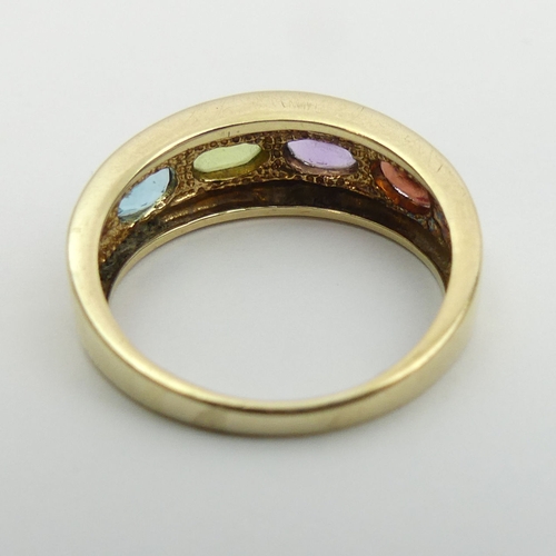 7 - 9ct gold peridot, topaz, amethyst and garnet ring. Size M 1/2, 7.2 mm wide. UK Postage £12.
