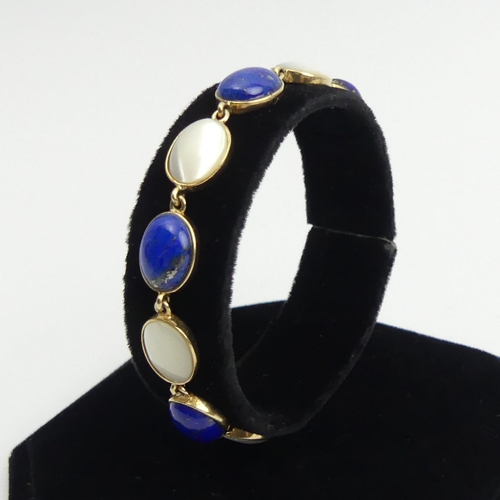 26 - 9ct gold lapis and moonstone cabochon bracelet, 10 grams, 17.5cm x 8.8mm. Postage £12