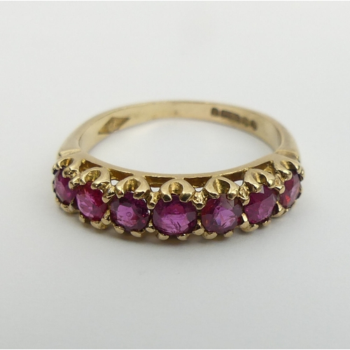 27 - 9ct gold seven stone ruby ring, 2 grams, size L 4.5mm wide.  UK Postage £12.