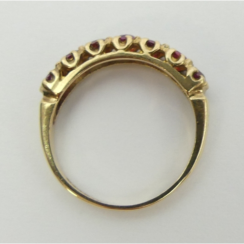 27 - 9ct gold seven stone ruby ring, 2 grams, size L 4.5mm wide.  UK Postage £12.
