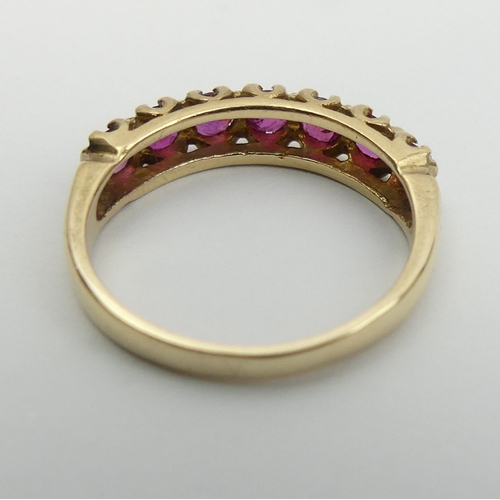 27 - 9ct gold seven stone ruby ring, 2 grams, size L 4.5mm wide.  UK Postage £12.