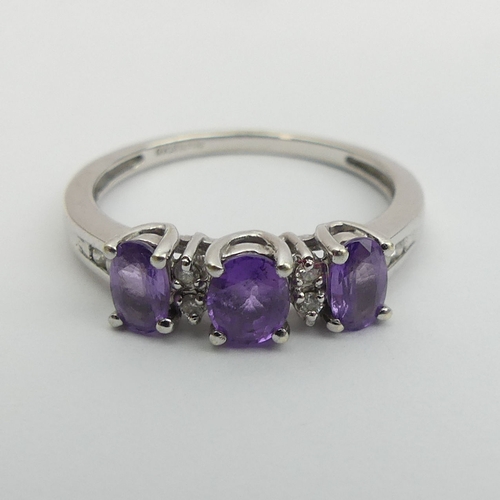 29 - 9ct white gold purple sapphire and diamond ring, 
2.3 grams, size N 5.2mm wide.  UK Postage £12.