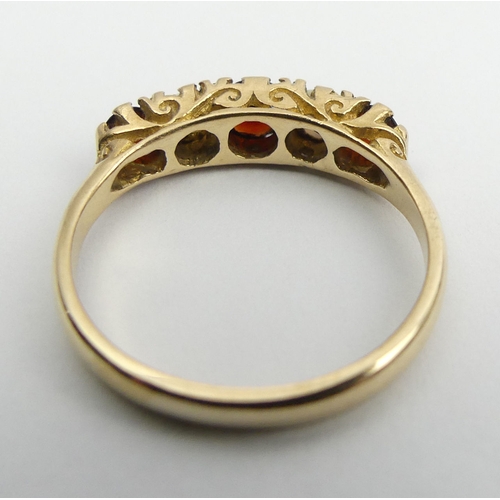 53 - 9ct gold garnet and opal five sone ring, 2.5 grams, Birm. 1967, Size P, 5mm wide. UK Postage £12