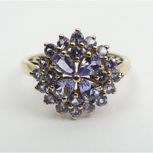 54 - 9ct gold blue tanzanite cluster ring, 2.3 grams, Size O, 14.4mm wide. UK Postage £12