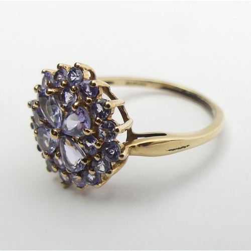 54 - 9ct gold blue tanzanite cluster ring, 2.3 grams, Size O, 14.4mm wide. UK Postage £12