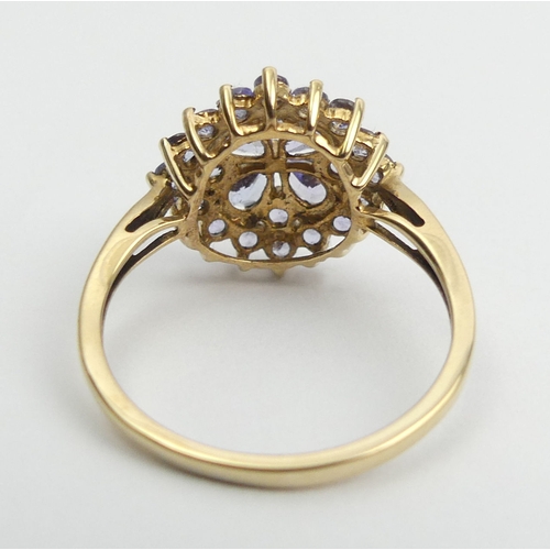 54 - 9ct gold blue tanzanite cluster ring, 2.3 grams, Size O, 14.4mm wide. UK Postage £12