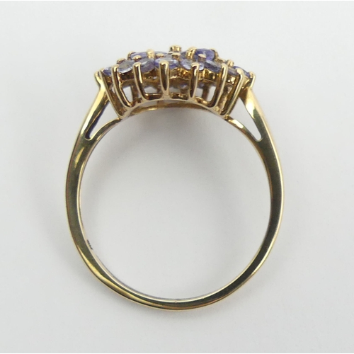 54 - 9ct gold blue tanzanite cluster ring, 2.3 grams, Size O, 14.4mm wide. UK Postage £12