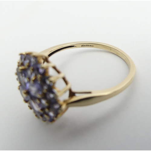 54 - 9ct gold blue tanzanite cluster ring, 2.3 grams, Size O, 14.4mm wide. UK Postage £12