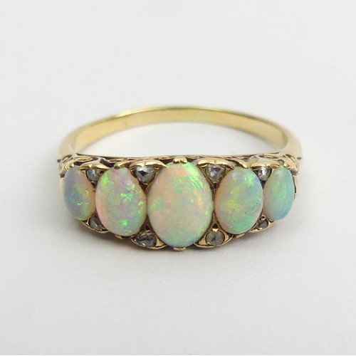 49 - 18ct gold, tested, opal five stone ring with diamond points. 3.9 grams, Size Q1/2, 7.4mm wide. 
UK P... 