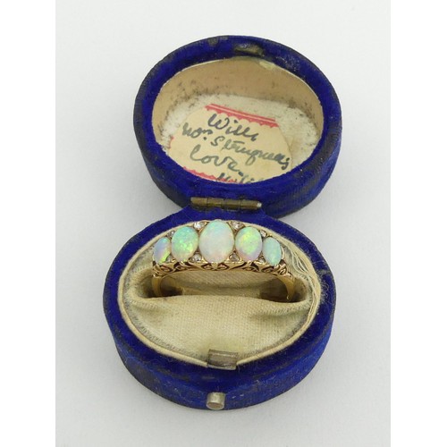 49 - 18ct gold, tested, opal five stone ring with diamond points. 3.9 grams, Size Q1/2, 7.4mm wide. 
UK P... 