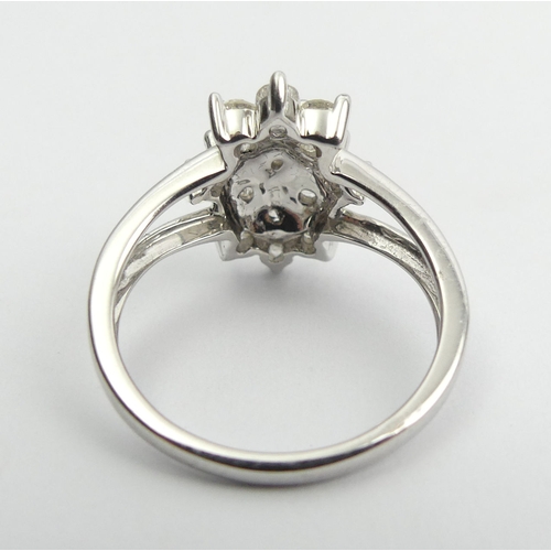 6 - 9ct white gold diamond, (approx .6ct) cluster ring, 3.8 grams, Size N1/2, 15mm wide. UK Postage £12