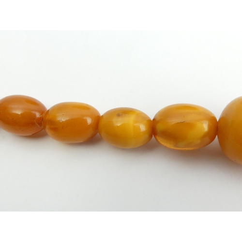 1 - Butterscotch amber bead 57cm long necklace with a 9ct gold clasp, 35 grams. Largest bead 24mm long. ... 