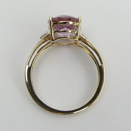 12 - 9ct gold oval pink topaz and diamond ring, 2.5 grams, 11mm wide, Size O. UK Postage £12