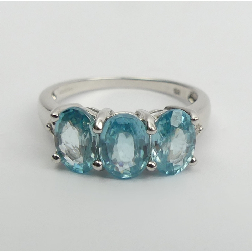 15 - 9ct white gold three stone blue topaz ring, 2.8 grams, 7.3mm wide, Size N1/2