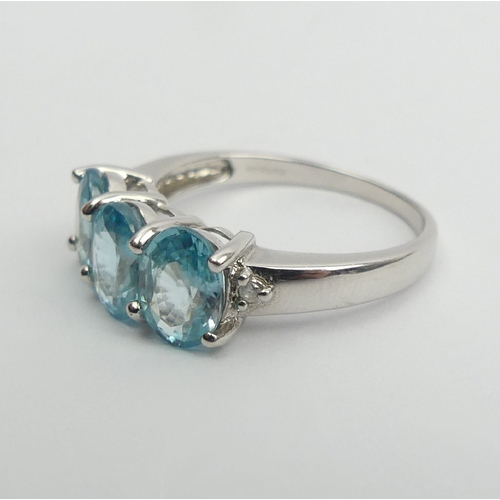 15 - 9ct white gold three stone blue topaz ring, 2.8 grams, 7.3mm wide, Size N1/2